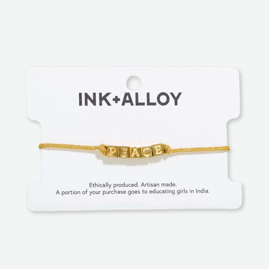 Goldie Gold Lurex Cord With Brass Letters Adjustable Peace Bracelet