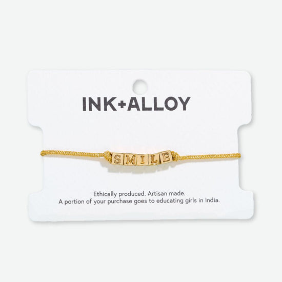 Goldie Gold Lurex Cord With Brass Letters Adjustable Smile Bracelet